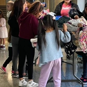 Migrant Families Being Given Clothing at P.S.1